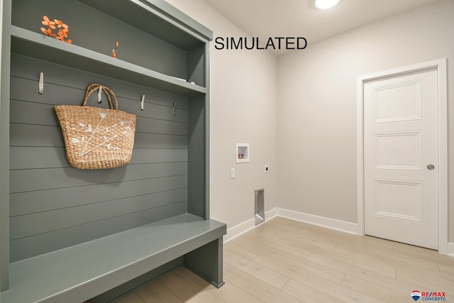 mudroom with light wood finished floors and baseboards