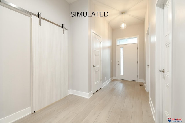 foyer featuring a barn door and light wood-type flooring