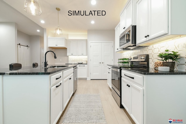 kitchen featuring white cabinetry, appliances with stainless steel finishes, and a sink