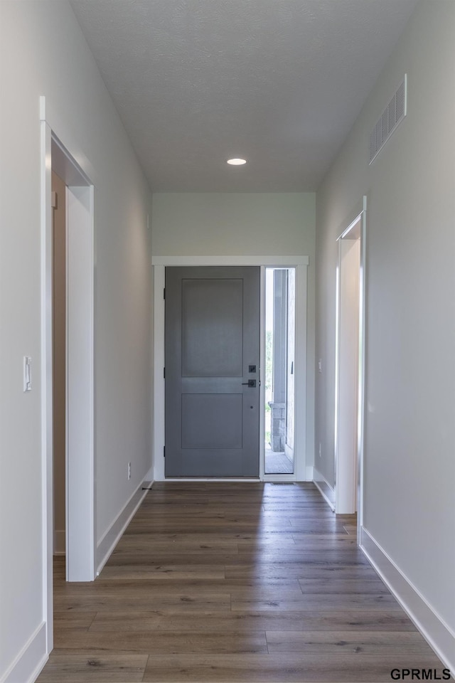 foyer entrance featuring recessed lighting, wood finished floors, visible vents, and baseboards