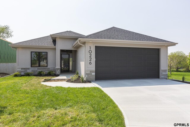 view of front of property with a front lawn and a garage