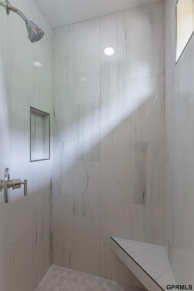 full bathroom with a tile shower