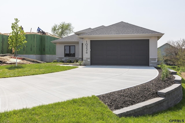 view of front of home with an attached garage, a shingled roof, stone siding, driveway, and stucco siding