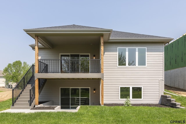 rear view of property with stairs, a shingled roof, and a lawn