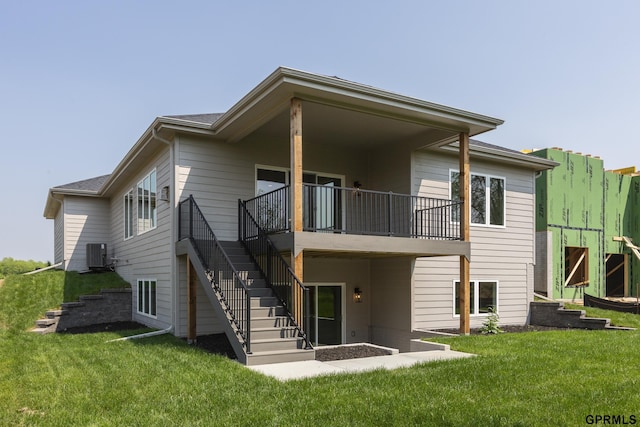 rear view of house with stairs, a lawn, and cooling unit