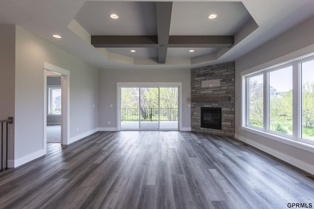 unfurnished living room featuring beam ceiling, baseboards, coffered ceiling, and dark wood finished floors