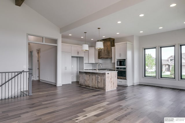 kitchen with white cabinets, an island with sink, hanging light fixtures, and stainless steel oven