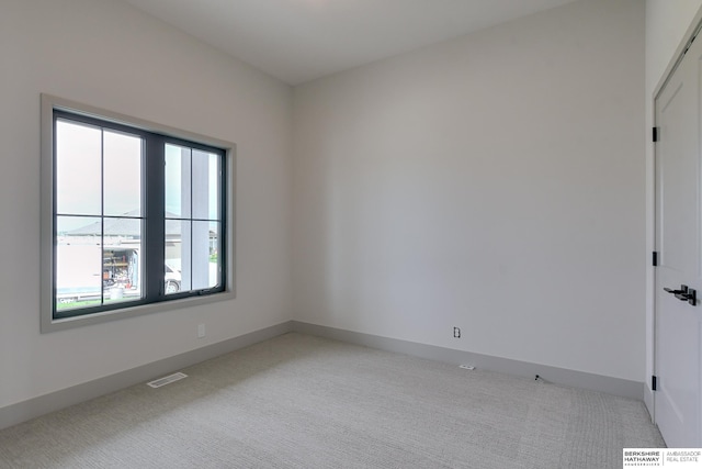 spare room with light colored carpet