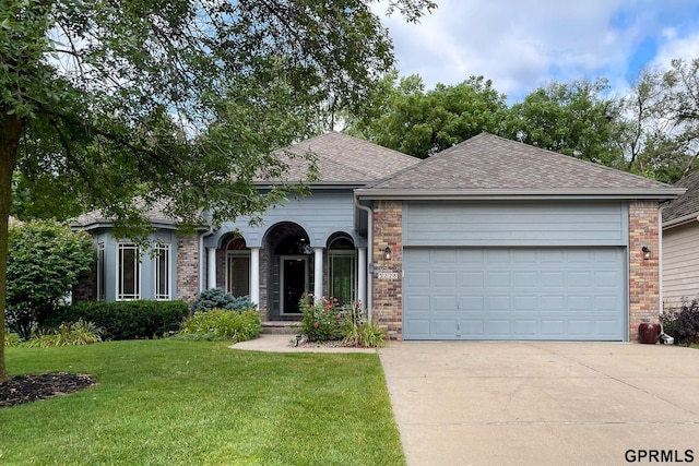 view of front of property with a front yard and a garage