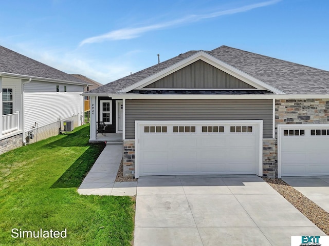 view of front of house featuring a garage, central AC, and a front yard