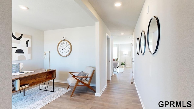 corridor with light hardwood / wood-style floors