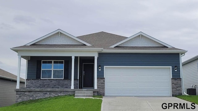 view of front of property featuring central AC, a garage, and a porch