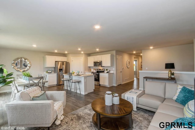 living room with dark hardwood / wood-style flooring