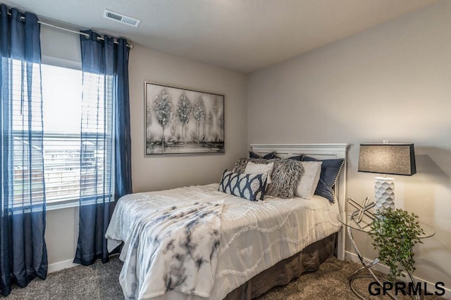 carpeted bedroom featuring visible vents and baseboards