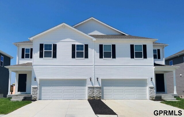 view of front facade featuring a garage and a front lawn