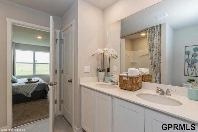 bathroom featuring tile patterned flooring, toilet, and vanity