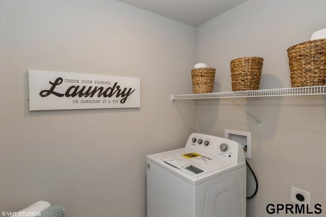 clothes washing area featuring washer / dryer