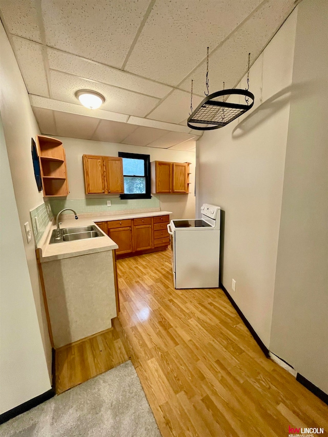 kitchen with a paneled ceiling, sink, white electric range, and light hardwood / wood-style floors