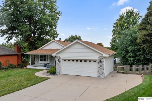 single story home with a garage and a front lawn