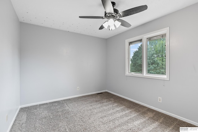 carpeted empty room featuring ceiling fan