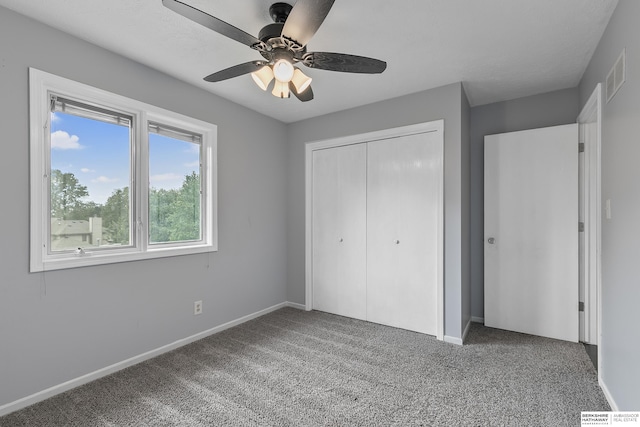 unfurnished bedroom with carpet flooring, a closet, and ceiling fan