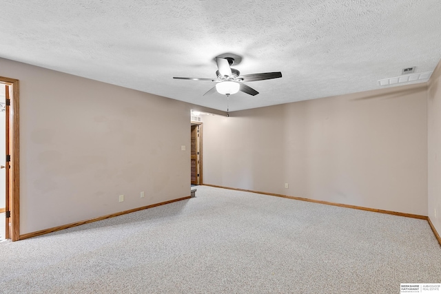 carpeted empty room featuring ceiling fan and a textured ceiling