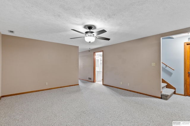 empty room featuring a textured ceiling and ceiling fan