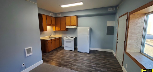 kitchen featuring dark wood-type flooring, sink, white appliances, and heating unit