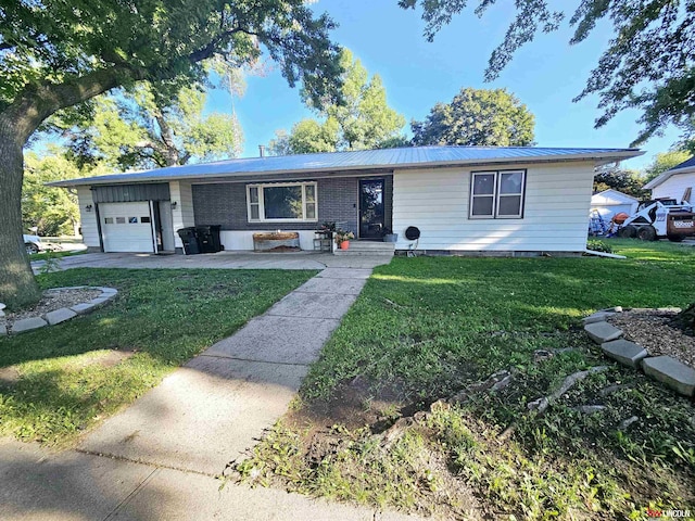 single story home featuring a front yard, a garage, and metal roof