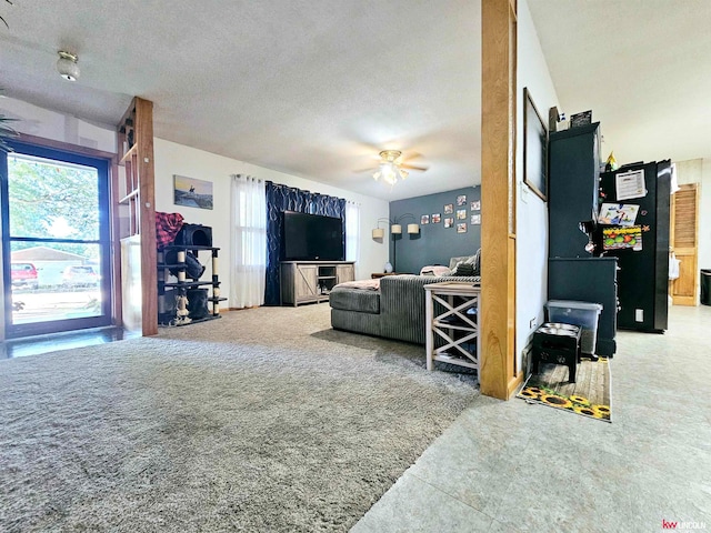 living room featuring a textured ceiling, a healthy amount of sunlight, and ceiling fan