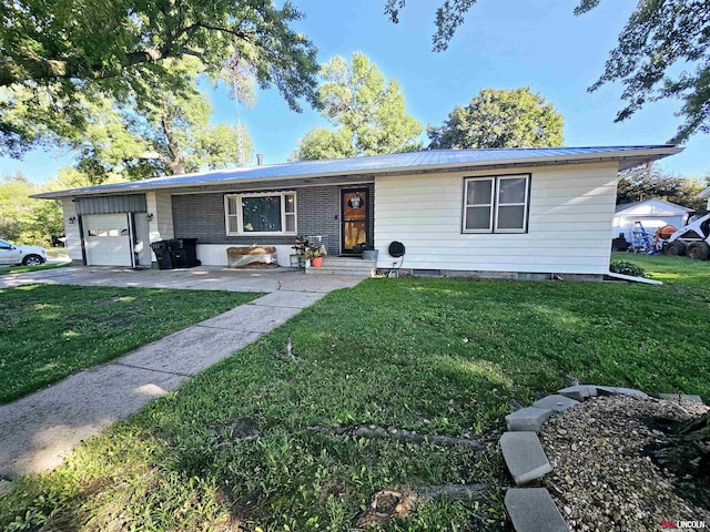 ranch-style home with a front yard, a garage, and metal roof