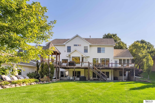 rear view of house with a yard and a wooden deck