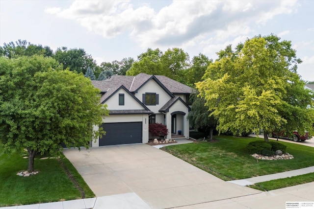 view of front of home with a garage and a front lawn