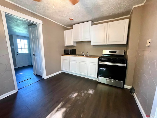 kitchen featuring white cabinets, stainless steel appliances, dark hardwood / wood-style floors, and a textured ceiling