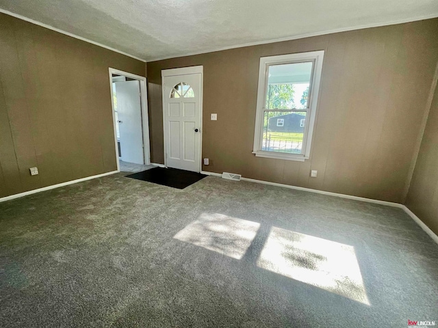 carpeted entryway with a textured ceiling