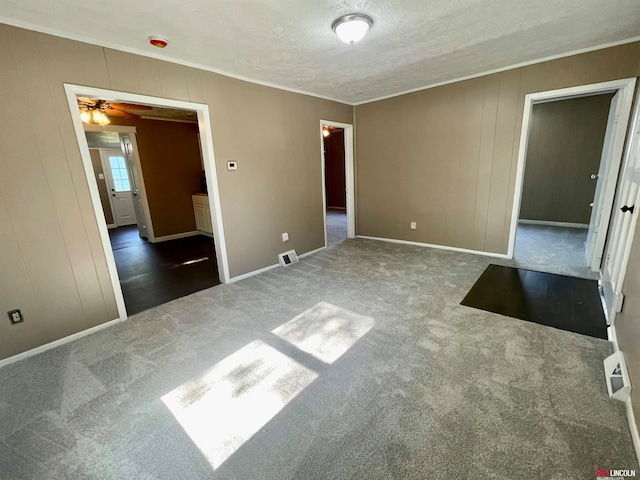 carpeted empty room with a textured ceiling and ceiling fan