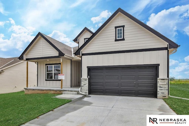 view of front of property with a garage and a front lawn