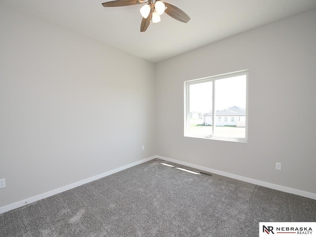 unfurnished room featuring baseboards, carpet floors, and ceiling fan