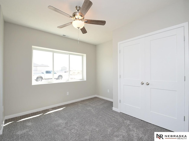 unfurnished bedroom featuring visible vents, baseboards, carpet, a closet, and a ceiling fan