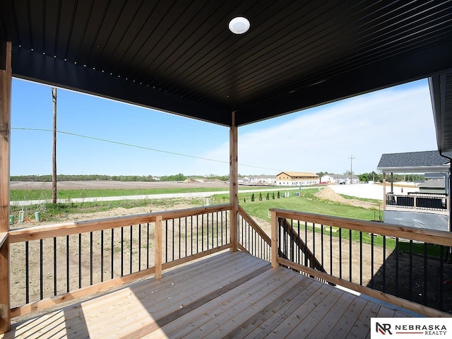 wooden deck featuring a rural view