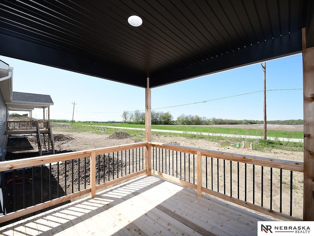 wooden deck featuring a rural view