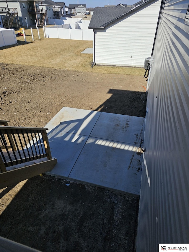 view of yard featuring a patio area, a residential view, and fence