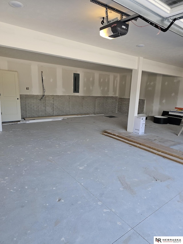 garage with electric panel and a garage door opener