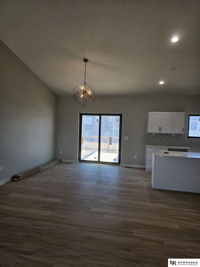 interior space featuring a chandelier, recessed lighting, baseboards, and dark wood-style flooring