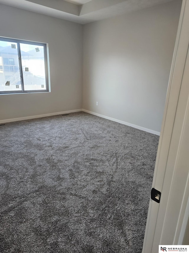 carpeted spare room with baseboards