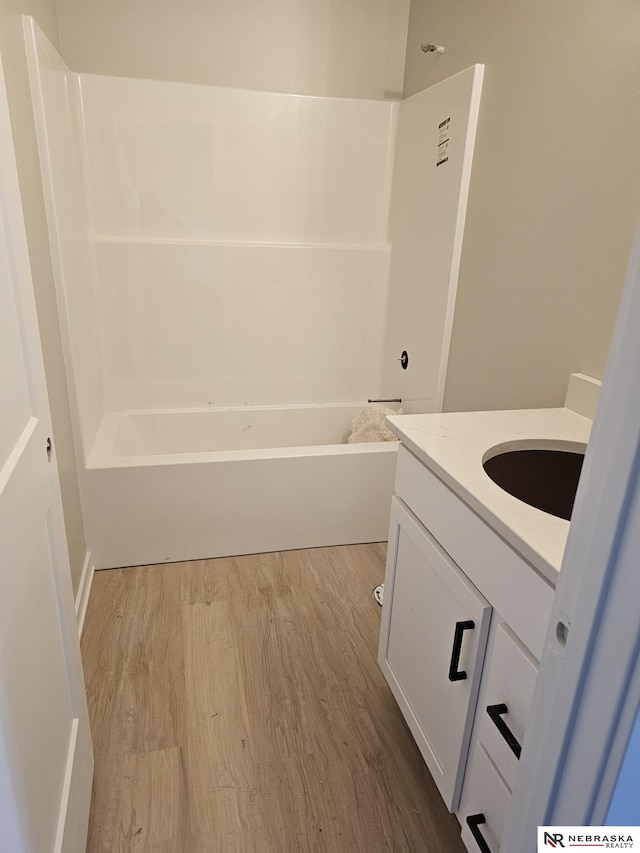 full bathroom featuring vanity, bathing tub / shower combination, and wood finished floors