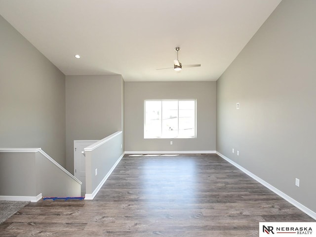 spare room featuring ceiling fan, baseboards, and wood finished floors