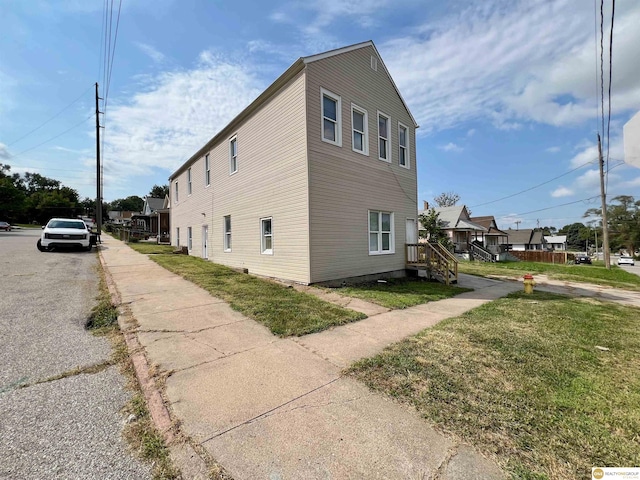 view of property exterior with a yard