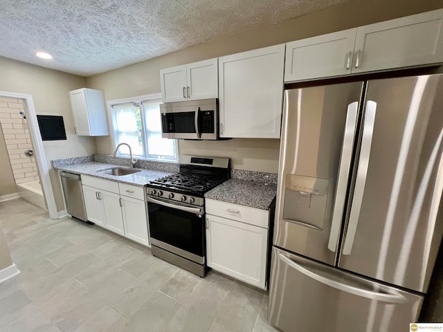 kitchen featuring white cabinetry, appliances with stainless steel finishes, and sink