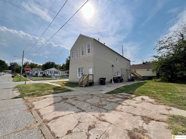 view of property exterior with a lawn